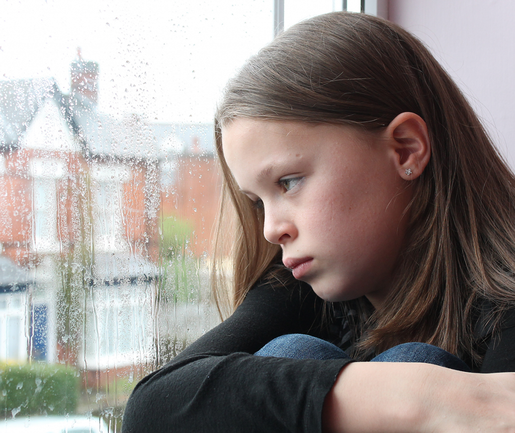 Violence in Fostering - Child looking out of a window.